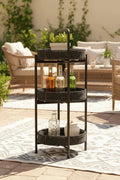 Outdoor patio scene with a bar cart holding drinks and plants.